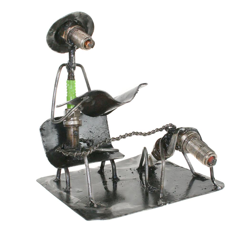 Model made from spark plugs, man with dog