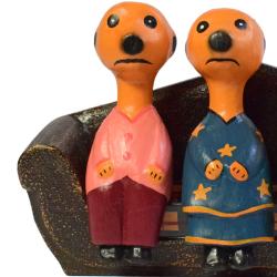 Meerkat family of 4 on sofa hand-carved from Albesia wood