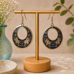 Earrings round black with gold coloured elephants