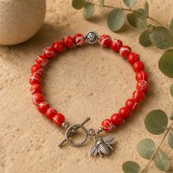 Bracelet with orange beads and bee