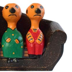 Meerkat family of 4 on sofa hand-carved from Albesia wood