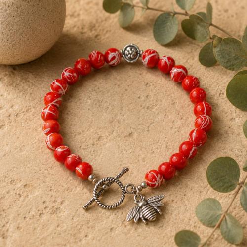 Bracelet with orange beads and bee