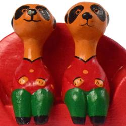 2 Meerkats on a red sofa hand carved from Albesia wood